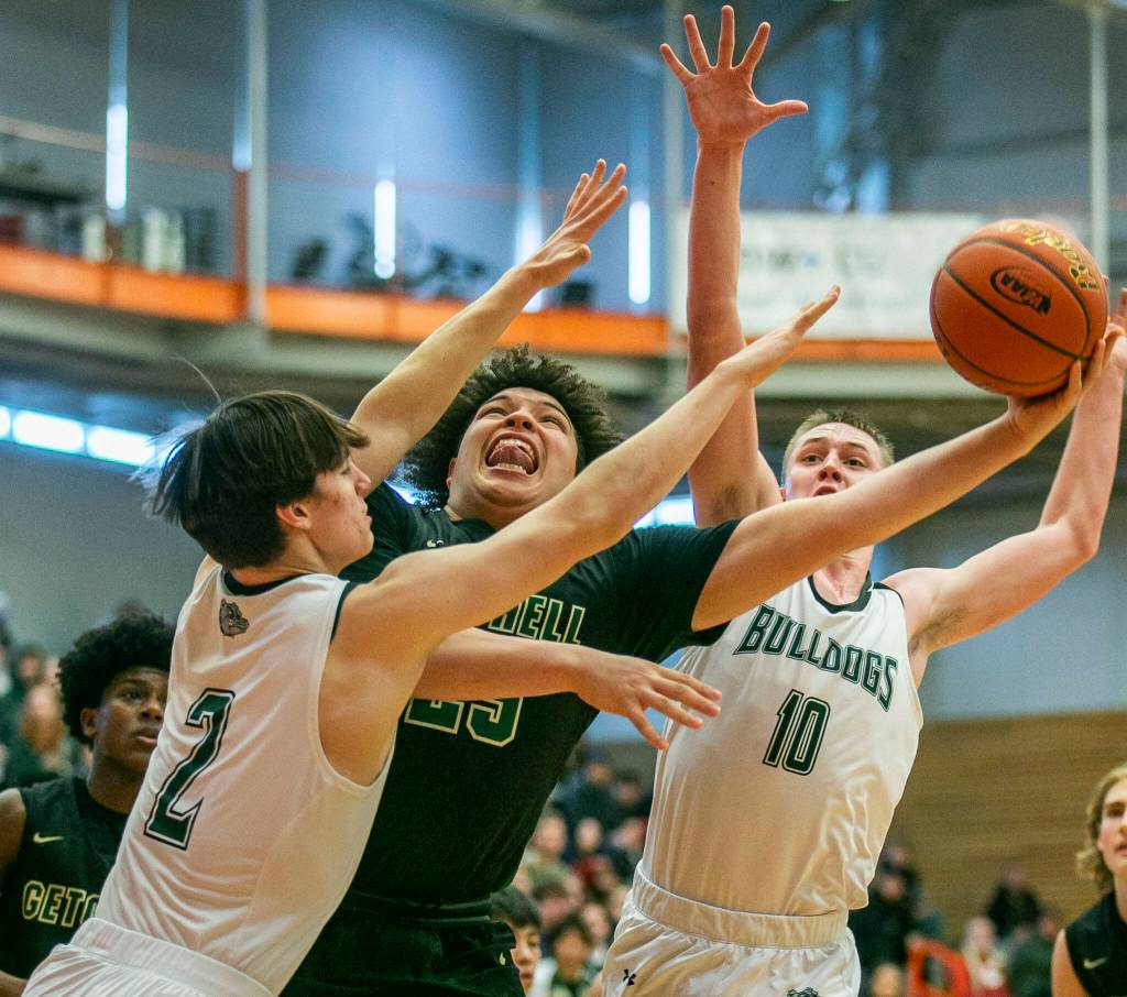 Marysville-Getchells Jayden Sellers attempts a layup being been double teamed during the game against Mount Vernon on Friday, Feb. 17, 2023 in Everett, Washington. (Olivia Vanni / The Herald)