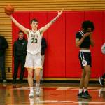 Shorecrests Parker Baumann raises his arms in celebration after beating Everett on Friday, Feb. 17, 2023 in Everett, Washington. (Olivia Vanni / The Herald)