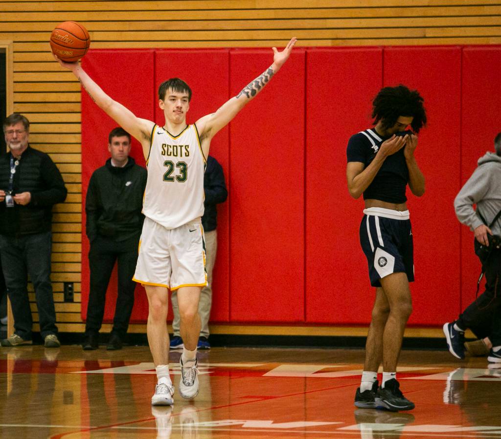 Shorecrests Parker Baumann raises his arms in celebration after beating Everett on Friday, Feb. 17, 2023 in Everett, Washington. (Olivia Vanni / The Herald)