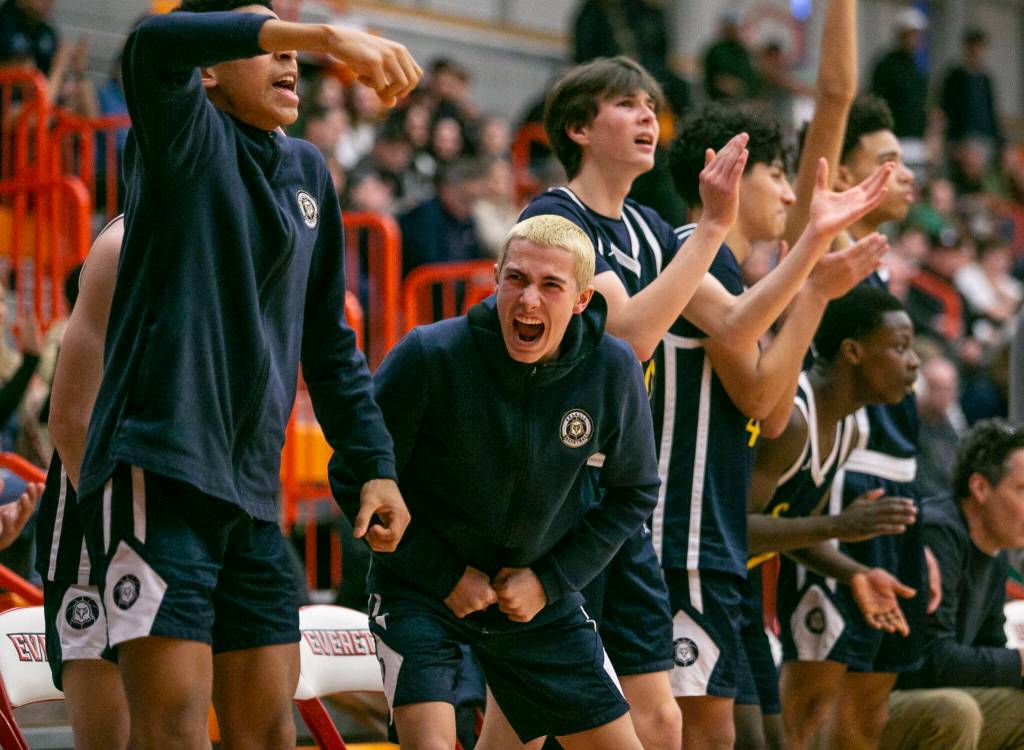 The Everett bench reacts to a three point shot during the game against Shorecrest on Friday, Feb. 17, 2023 in Everett, Washington. (Olivia Vanni / The Herald)