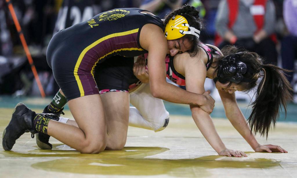 Marysville Getchells Kira Songer and Moses Lakes Ashley Dayana Naranjo wrestle in the 3A/4A Girls 115-pound championship match during the Mat Classic XXXIV at the Tacoma Dome in Tacoma, Washington on Saturday, Feb. 18, 2023. (Annie Barker / The Herald)