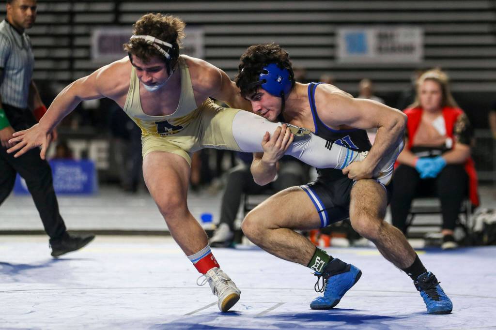 Arlingtons Dustin Baxter and Walla Wallas Mateo Caso wrestle during the 3A Boys 152-pound championship match during the Mat Classic XXXIV at the Tacoma Dome in Tacoma, Washington on Saturday, Feb. 18, 2023. (Annie Barker / The Herald)