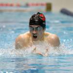 Snohomish sophomore Noah Collins looks over at his opponents during the 200 yard individual medley consolation race at the 3A WIAA Boys High School Swim and Dive Championships on Friday, Feb. 18, 2023, at the Weyerhaeuser King County Aquatic Center in Federal Way, Washington. (Ryan Berry / The Herald)