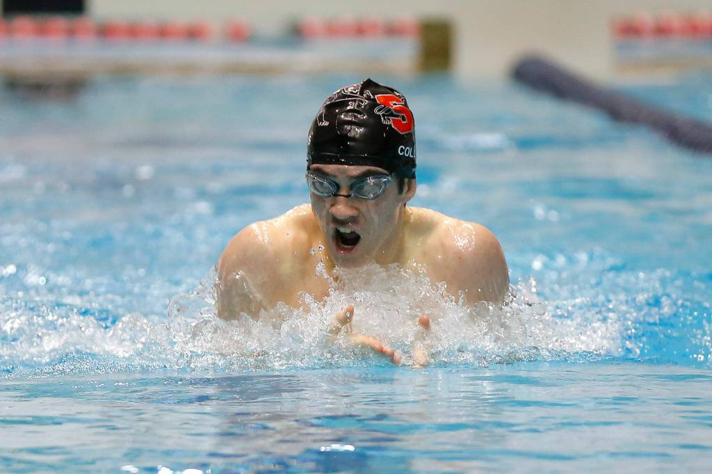Snohomish sophomore Noah Collins looks over at his opponents during the 200 yard individual medley consolation race at the 3A WIAA Boys High School Swim and Dive Championships on Friday, Feb. 18, 2023, at the Weyerhaeuser King County Aquatic Center in Federal Way, Washington. (Ryan Berry / The Herald)