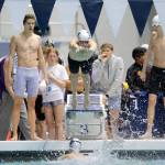 Woodinville junior Carter Johnson dives in as teammate Alex Popov finishes his leg during the 200 yard freestyle relay consolation race at the 4A WIAA Boys High School Swim and Dive Championships on Friday, Feb. 18, 2023, at the Weyerhaeuser King County Aquatic Center in Federal Way, Washington. (Ryan Berry / The Herald)