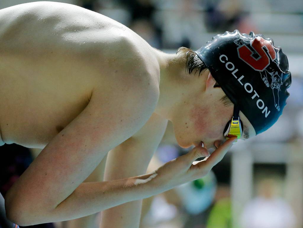 Snohomish sophomore Connor Colloton adjusts his goggles prior to the 400 yard freestyle relay consolation race at the 3A WIAA Boys High School Swim and Dive Championships on Friday, Feb. 18, 2023, at the Weyerhaeuser King County Aquatic Center in Federal Way, Washington. (Ryan Berry / The Herald)