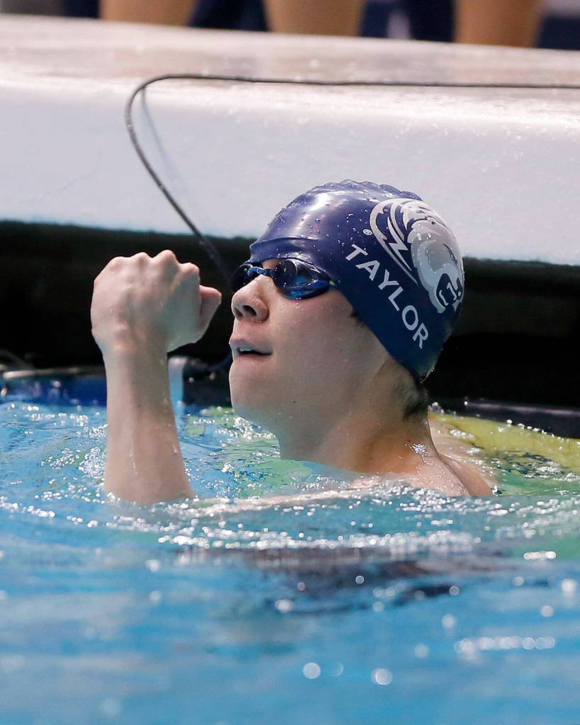 Glacier Peaks Kaiu Taylor pumps his fist after finishing the 50 yard freestyle consolation race at the 4A WIAA Boys High School Swim and Dive Championships on Friday, Feb. 18, 2023, at the Weyerhaeuser King County Aquatic Center in Federal Way, Washington. (Ryan Berry / The Herald)