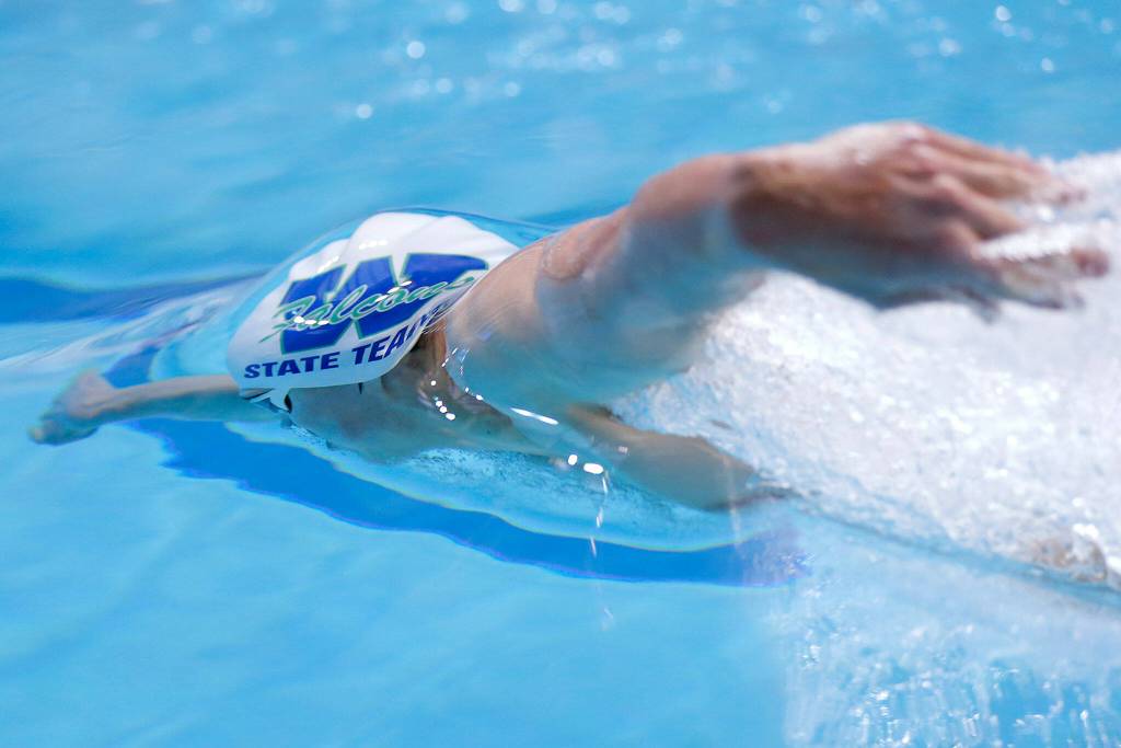 Woodinville senior Alex Popov swims below the surface after taking a turn in the 200 yard independent medley consolation race at the 4A WIAA Boys High School Swim and Dive Championships on Friday, Feb. 18, 2023, at the Weyerhaeuser King County Aquatic Center in Federal Way, Washington. (Ryan Berry / The Herald)
