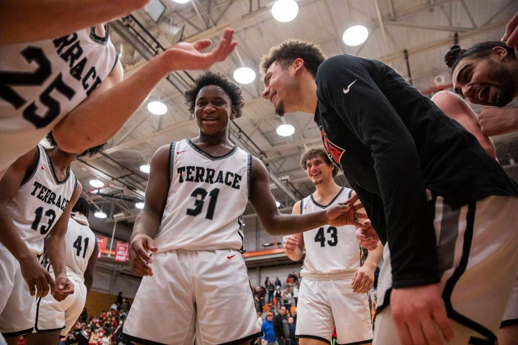 Mountlake Terrace players celebrate beating Arlington to become the 3A District 1 champions on Saturday, Feb. 18, 2023 in Everett, Washington. (Olivia Vanni / The Herald)