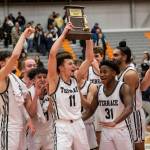 Mountlake Terraces Chris Meegan lifts the 3A District 1 championship trophy in the air after being Arlington on Saturday, Feb. 18, 2023 in Everett, Washington. (Olivia Vanni / The Herald)