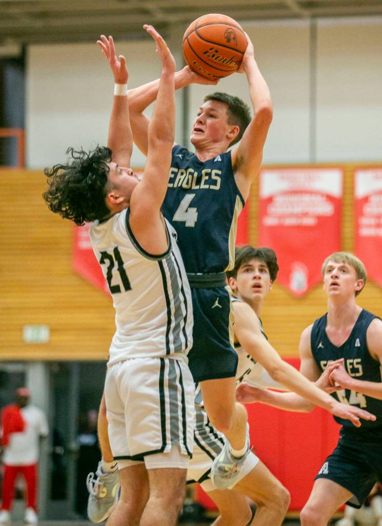 Arlingtons Ty Rusko attempts a jump shot while being guarded during the game against Mountlake Terrace on Saturday, Feb. 18, 2023 in Everett, Washington. (Olivia Vanni / The Herald)