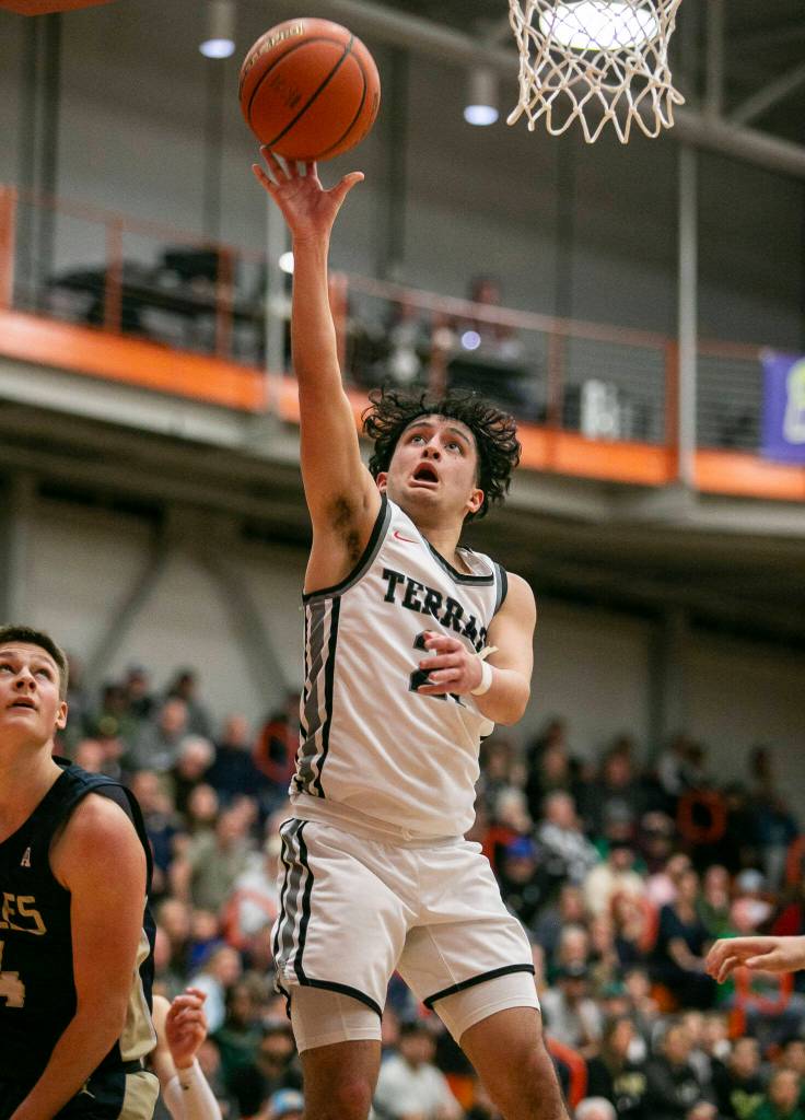 Mountlake Terraces Logan Tews makes a lay up during the game against Arlington on Saturday, Feb. 18, 2023 in Everett, Washington. (Olivia Vanni / The Herald)