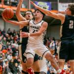 Mountlake Terraces Logan Tews is fouled while trying to make a layup during the game against Arlington on Saturday, Feb. 18, 2023 in Everett, Washington. (Olivia Vanni / The Herald)
