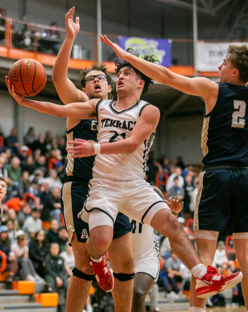 Mountlake Terraces Logan Tews is fouled while trying to make a layup during the game against Arlington on Saturday, Feb. 18, 2023 in Everett, Washington. (Olivia Vanni / The Herald)