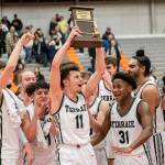Mountlake Terrace’s Chris Meegan lifts the 3A District 1 championship trophy in the air after being Arlington on Saturday, Feb. 18, 2023 in Everett, Washington. (Olivia Vanni / The Herald)