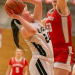 Arlingtons Katie Snow attempts a layup while guarded during the game against Stanwood on Saturday, Feb. 18, 2023 in Everett, Washington. (Olivia Vanni / The Herald)