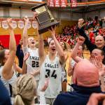 Arlingtons Jenna Villa lifts the 3A District 1 championship trophy in the air on Saturday, Feb. 18, 2023 in Everett, Washington. (Olivia Vanni / The Herald)