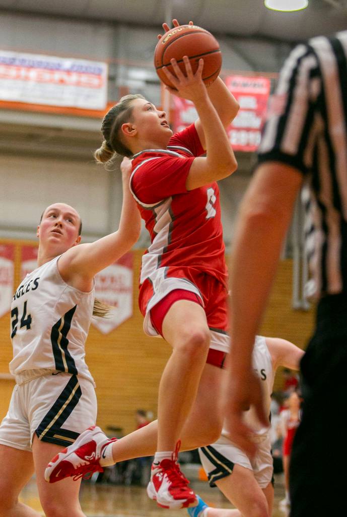 Stanwoods Grace Walker attempts a layup during the game against Arlington on Saturday, Feb. 18, 2023 in Everett, Washington. (Olivia Vanni / The Herald)