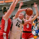 Arlingtons Katie Snow attempts a layup while double guarded during the game against Stanwood on Saturday, Feb. 18, 2023 in Everett, Washington. (Olivia Vanni / The Herald)