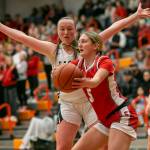 Stanwoods Ava Depew attempts to keep the ball away from Arlingtons Katie Snow during the game on Saturday, Feb. 18, 2023 in Everett, Washington. (Olivia Vanni / The Herald)