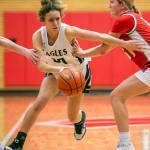 Arlingtons Samara Morrow is pushed as she drives to the hoop during the game against Stanwood on Saturday, Feb. 18, 2023 in Everett, Washington. (Olivia Vanni / The Herald)