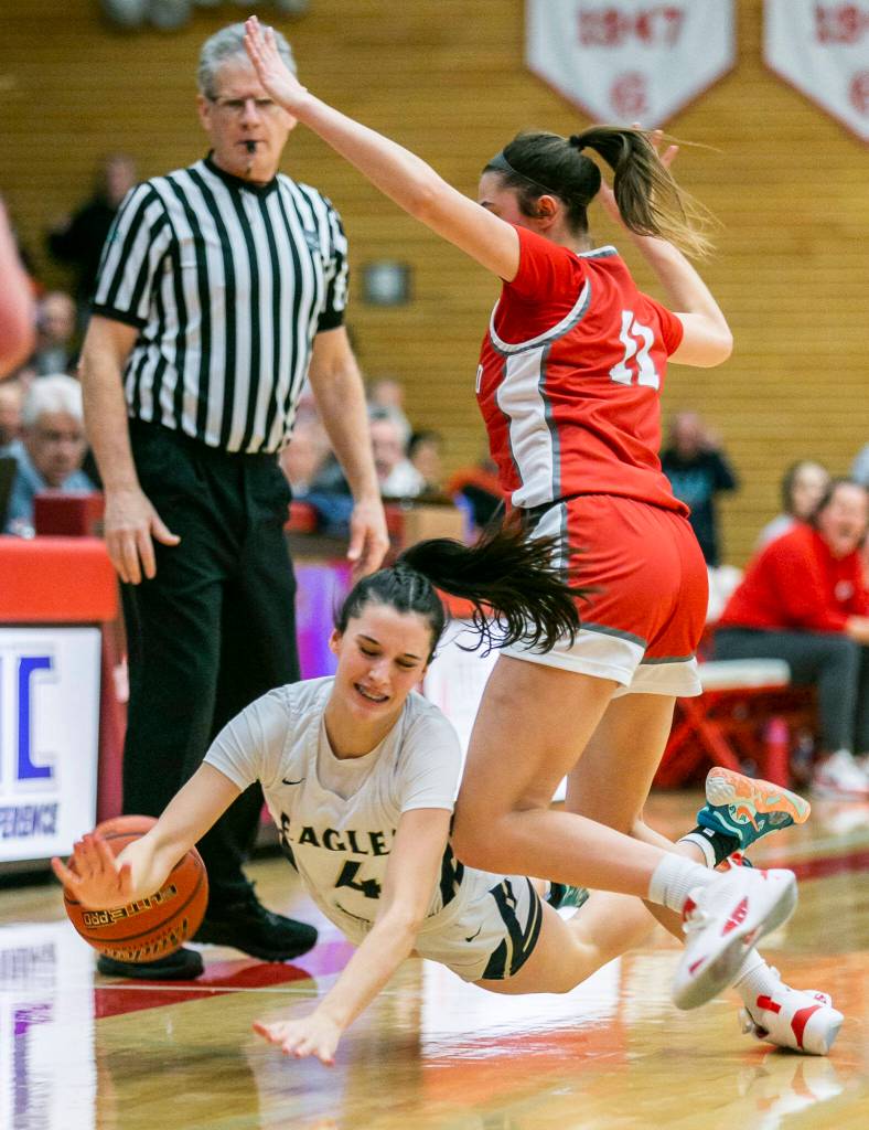 Arlingtons Maddy Fischer is fouled during the game against Stanwood on Saturday, Feb. 18, 2023 in Everett, Washington. (Olivia Vanni / The Herald)