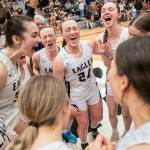 Arlignton players yell in celebration of becoming the 3A District 1 champions on Saturday, Feb. 18, 2023 in Everett, Washington. (Olivia Vanni / The Herald)
