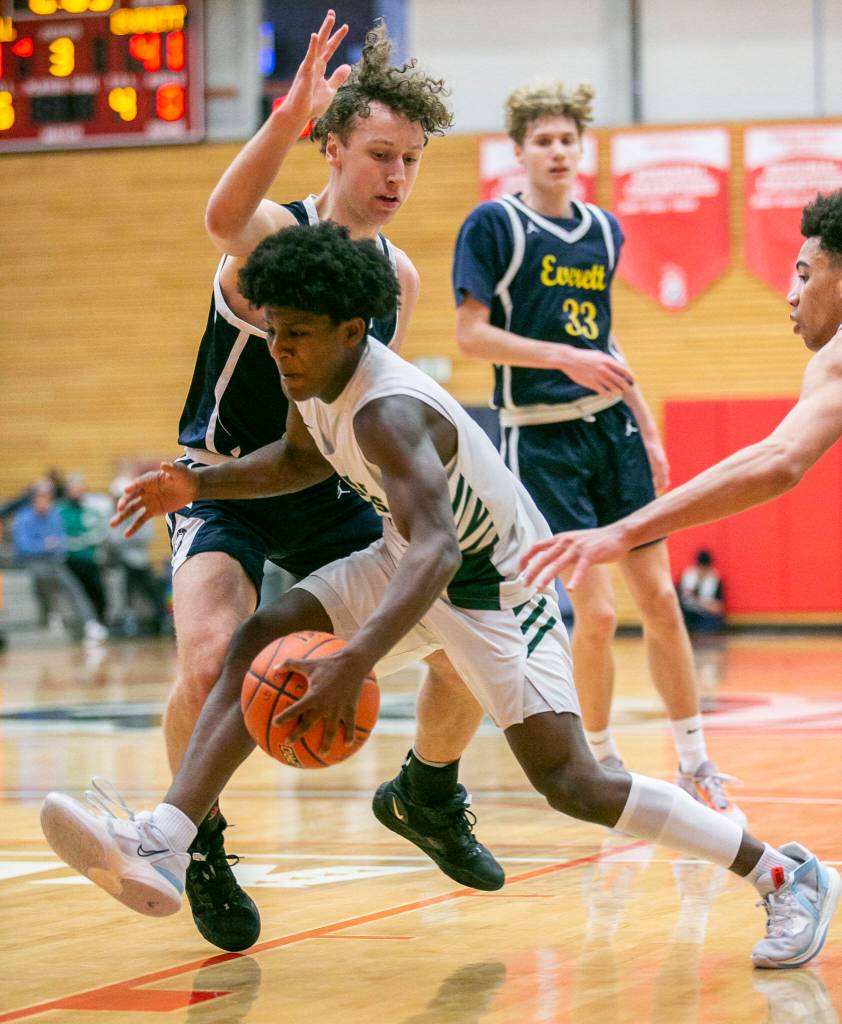 Marysville Getchells Shawn Etheridge is fouled while driving to the hoop during the game against Everett on Saturday, Feb. 18, 2023 in Everett, Washington. (Olivia Vanni / The Herald)