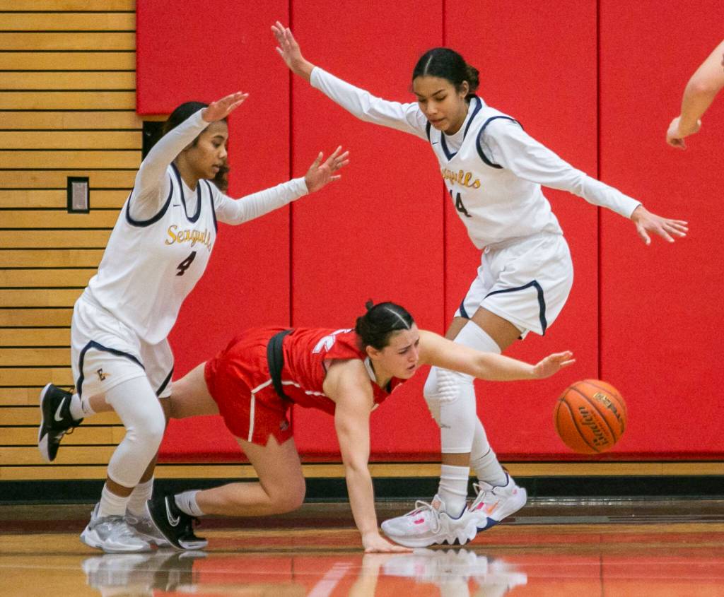Snohomishs Jada Andresen is tripped while being double guarded during the game against Everett on Saturday, Feb. 18, 2023 in Everett, Washington. (Olivia Vanni / The Herald)