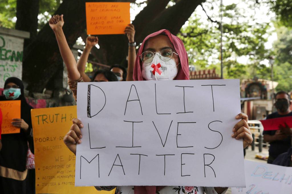 Demonstrators hold signs during a protest condemning the alleged gang rape and killing of a Dalit woman, in Bengaluru, India, Sunday, Oct. 4, 2020. Protestors have been demanding the dismissal of the government of the northern Indian state where the 19-year-old woman from the countrys lowest caste was allegedly gang raped and later died in a hospital. Dalits, formerly known as untouchables and at the bottom of Indias Hindu caste hierarchy, are victims of thousands of attacks each year. According to human rights organizations, Dalit women are particularly vulnerable to caste-based discrimination and sexual violence. (AP Photo/Aijaz Rahi, File)