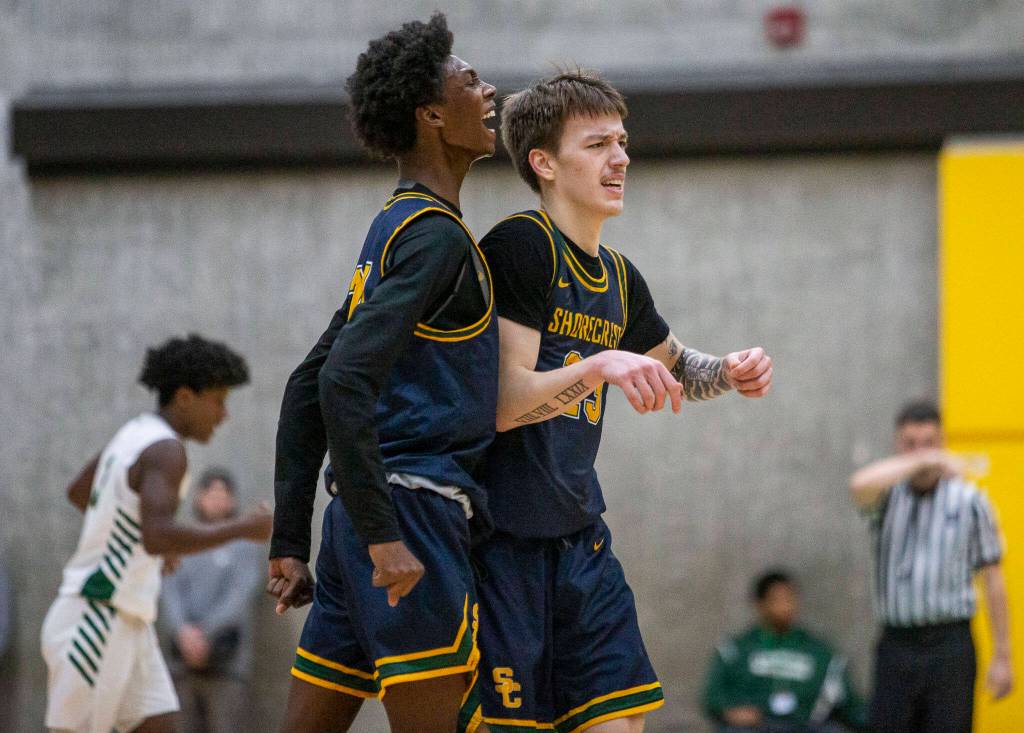 Shorecrests Adarrius Hilliard celebrates with Parker Baumann after making a 3-point shot during a game against Marysville Getchell on Dec. 16, 2022 in Marysville. The 16th-seeded Scots face ninth-seeded Gig Harbor on Saturday. (Olivia Vanni / The Herald)