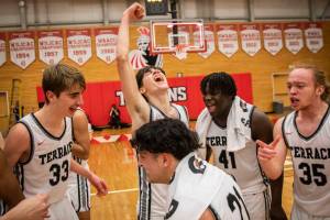 Mountlake Terrace players celebrate beating Arlington to become the 3A District 1 champions on Saturday, Feb. 18, 2023 in Everett, Washington. (Olivia Vanni / The Herald)