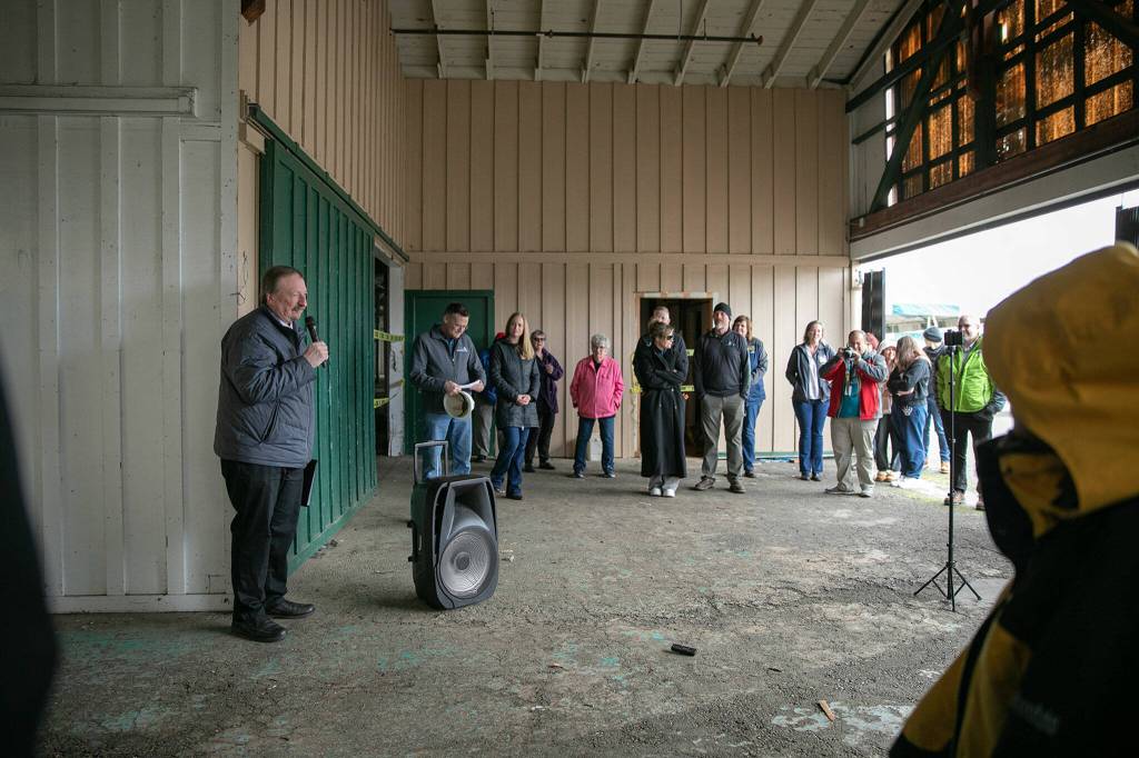 Members of the public gather for a brief ceremony during an event celebrating the impending demolition of Commercial Building No. 400 Tuesday, at the Evergreen State Fairgrounds in Monroe. (Ryan Berry / The Herald)