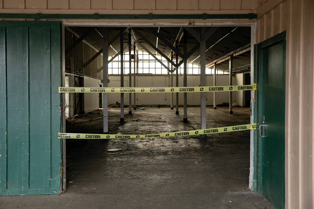 The inside of Commercial Building No. 400 is taped off during an event celebrating the impending demolition of the derelict space Tuesday, at the Evergreen State Fairgrounds in Monroe. (Ryan Berry / The Herald)