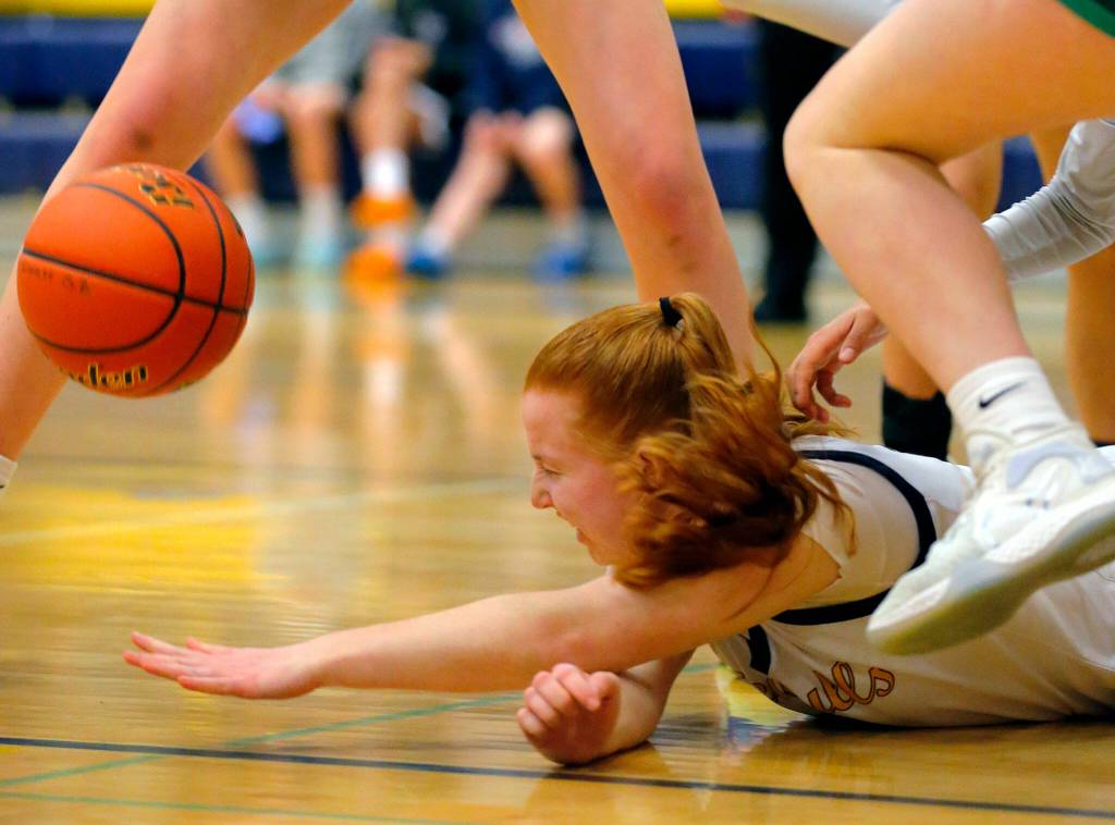 Everetts Annabelle Lawless hits the ground while trying to secure an offensive rebound against Bishop Blanchet during a first round playoff game on Tuesday, Feb. 21, 2023, at the Norm Lowery Gymnasium in Everett, Washington. (Ryan Berry / The Herald)