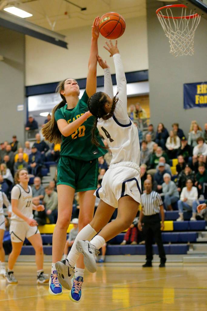 Bishop Blanchets Emerson Ludwick blocks a shot by Everetts Mylie Wugumgeg during a first round playoff game on Tuesday, Feb. 21, 2023, at the Norm Lowery Gymnasium in Everett, Washington. (Ryan Berry / The Herald)