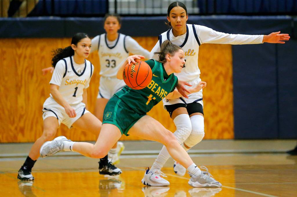 Bishop Blanchets Sadie Graves tries to get past a defender against Everett during a first round playoff game on Tuesday, Feb. 21, 2023, at the Norm Lowery Gymnasium in Everett, Washington. (Ryan Berry / The Herald)