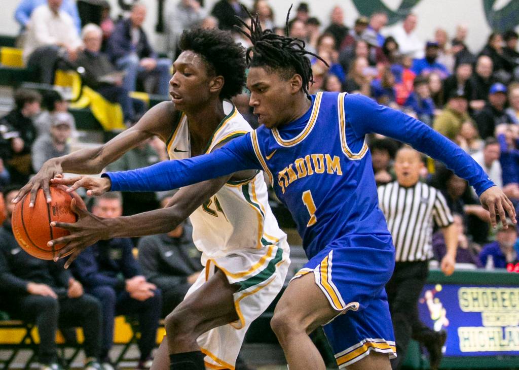 Shorecrests Adarrius Hilliard and Stadiums Baaroc Rivers both reach out to grab the ball during the game against Stadium on Tuesday, Feb. 21, 2023 in Shoreline, Washington. (Olivia Vanni / The Herald)