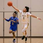 Shorecrests Keaine Silimon reaches out to get control of the ball during the game against Stadium on Tuesday, Feb. 21, 2023 in Shoreline, Washington. (Olivia Vanni / The Herald)