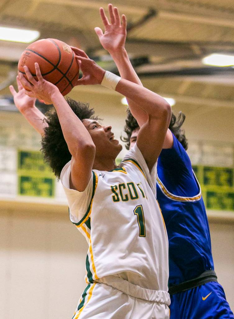 Shorecrests Keaine Silimon attempts a layup while being guarded during the game against Stadium on Tuesday, Feb. 21, 2023 in Shoreline, Washington. (Olivia Vanni / The Herald)