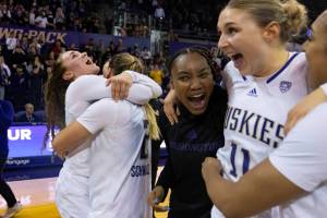 Washington players including guard guard Elle Ladine, far left, forward Lauren Schwartz, second from left, and forward Haley Van Dyke, second from right, celebrate after an NCAA college basketball game against Stanford, Sunday, Feb. 5, 2023, in Seattle. Washington won 72-67. (AP Photo/Stephen Brashear)