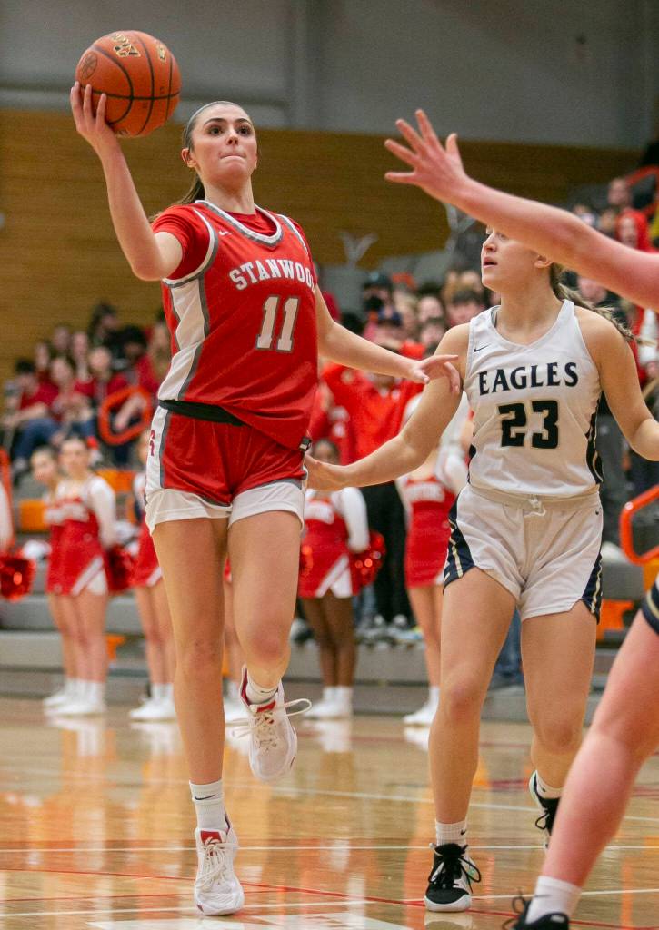 Stanwoods Tatum Brager attempts to pass the pall to a teammate during the game against Arlington on Saturday, Feb. 18, 2023 in Everett, Washington. (Olivia Vanni / The Herald)