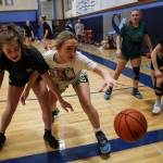 Sultans Wendy Asper (left) and Taylor Cushing (right) reach for the ball during a girls basketball practice at Sultan High School on Thursday. (Annie Barker / The Herald)