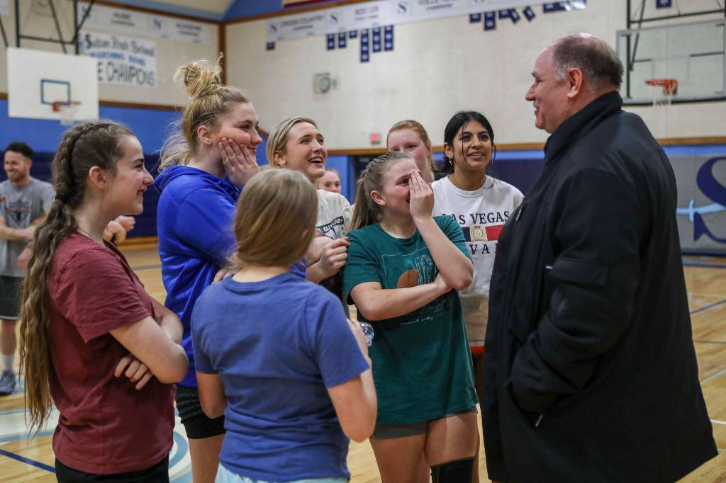 Sultan boys head basketball coach Nate Trichler (right) speaks to the girls basketball team during a practice at Sultan High School on Thursday. (Annie Barker / The Herald)