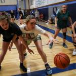 Wendy Asper (4), left, and Taylor Cushing (3), right, reach for the ball during a girls basketball practice at Sultan High School in Sultan, Washington on Thursday, Feb. 23, 2023. The Turks made the state playoffs for the first time in program history. (Annie Barker / The Herald)