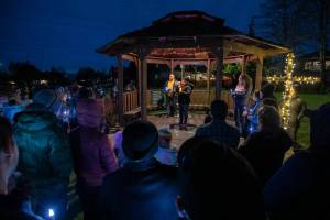 Nurses and community members gather at Drew Nielsen Neighborhood Park while Valerie Whorton, RN, BSN, speaks about the need for safer staffing standards in light of increasing patient loads at Providence on Saturday, Feb. 25, 2023 in Everett, Washington. (Olivia Vanni / The Herald)
