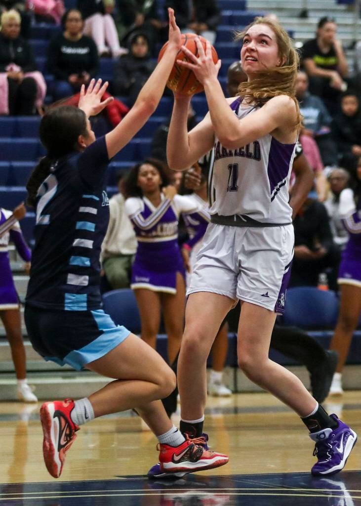 Garfields Sarah Lessig (11) shoots the ball during a 3A girls basketball state regional game against Meadowdale at the Courter Family Athletic Pavilion in Bellevue on Friday. Garfield won 62-48. (Annie Barker / The Herald)