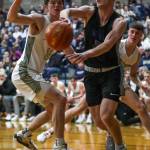 Walla Wallas Daniel Coram (2) passes the ball during a state playoff game against Arlington at Arlington High School on Saturday. Arlington won 68-57. (Annie Barker / The Herald)