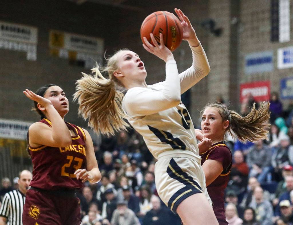 Arlingtons Kierra Reese (22) shoots the ball during a state playoff game against Lakeside at Arlington High School on Saturday. Arlington won 75-63. (Annie Barker / The Herald)