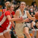 Arlington’s Jenna Villa tries to maneuver around a defender during the game against Stanwood on Saturday, Feb. 18, 2023 in Everett, Washington. (Olivia Vanni / The Herald)